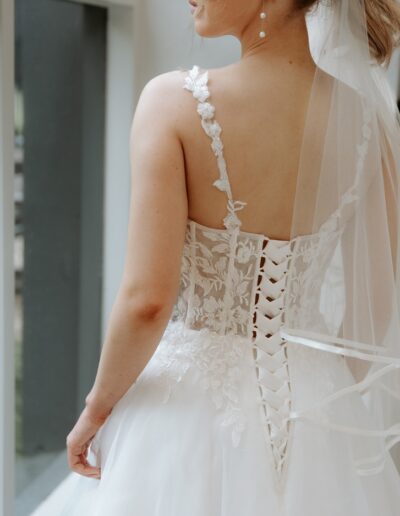 Square neckline wedding dress with open lace corset bodice and organza skirt with flower straps